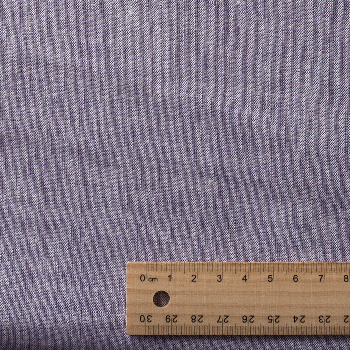 Yarn-dyed Lilac Fizz linen fabric with white and lilac threads, featuring natural slubs for a textured look and feel.
