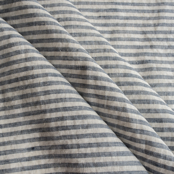 Close-up of blue and white striped Marine Stripe 100% Linen Fabric fabric