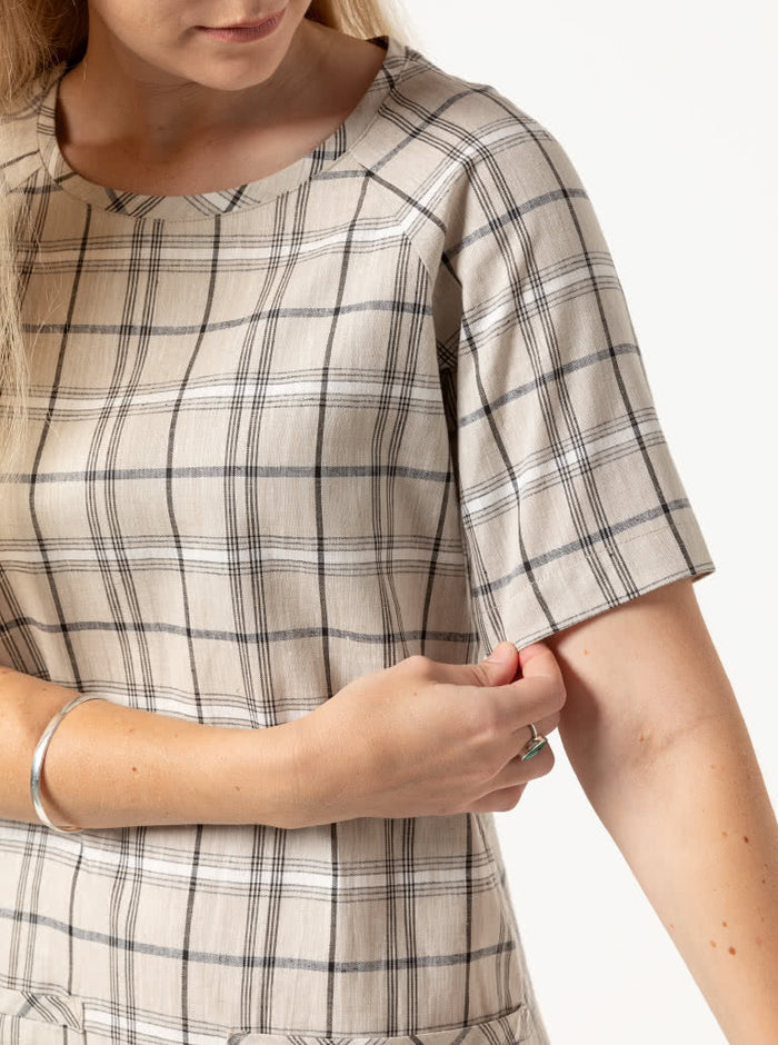 A stylish Mary shift dress pattern with raglan sleeves and patch pockets, ideal for creating a classic knee-length dress in woven fabrics.