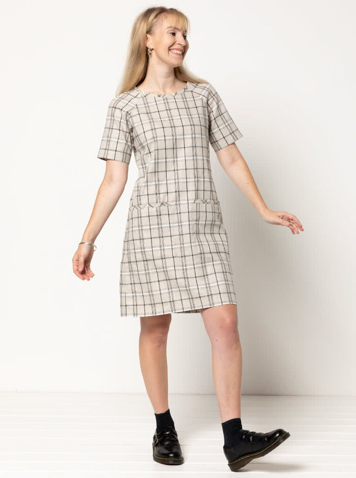 A stylish Mary shift dress pattern with raglan sleeves and patch pockets, ideal for creating a classic knee-length dress in woven fabrics.