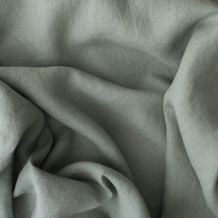 Close-up of Misty Sage extra wide 280cm 100% linen fabric 300gsm for jackets, aprons, cushions, curtains and structured home textiles with folds