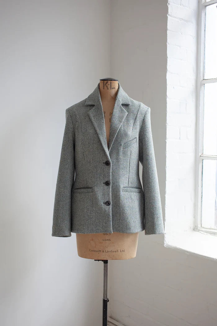 Gray blazer made using Naomi Blazer PDF Sewing Pattern  on a mannequin against a white wall with natural light.