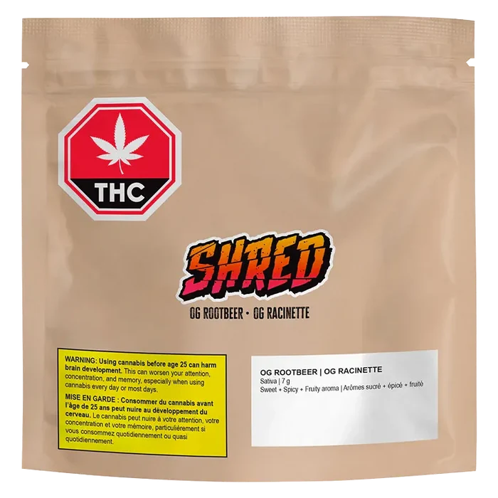 Front-facing shot of a tan pouch labeled "OG Rootbeer" with a colorful SHRED logo, THC warning icon, and ingredient panel.
