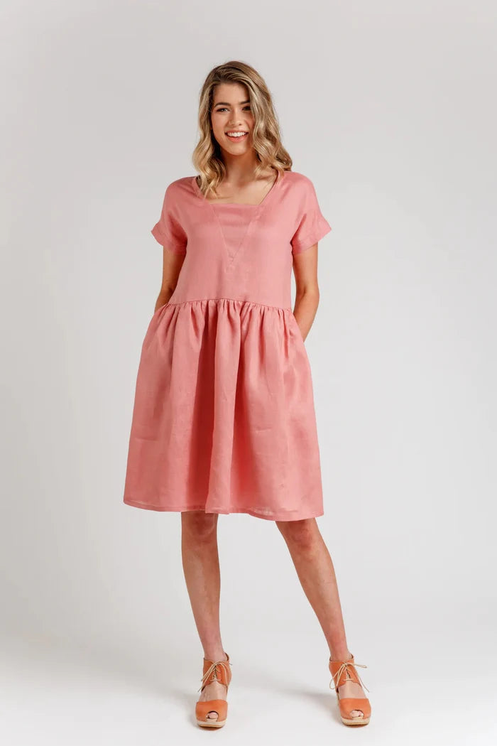 A relaxed silhouette Olive dress and top sewing pattern with a v-insert, drop shoulder, and multiple sleeve options, perfect for creating versatile garments.