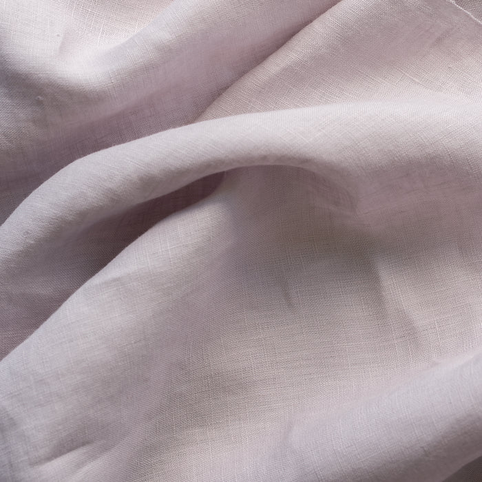Close-up of light lilac-mauve inen fabric with visible texture