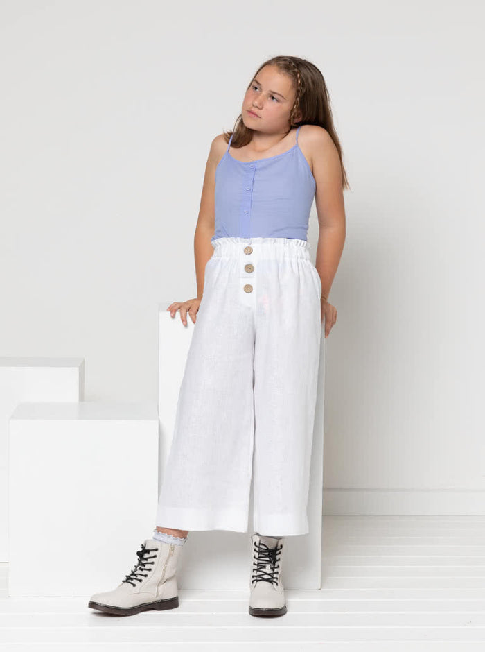 Chic Penny Teens swing dress or top sewing pattern featuring a shirred back panel, rouleau straps, and a faux button opening, designed for cotton, linen, and rayon fabrics