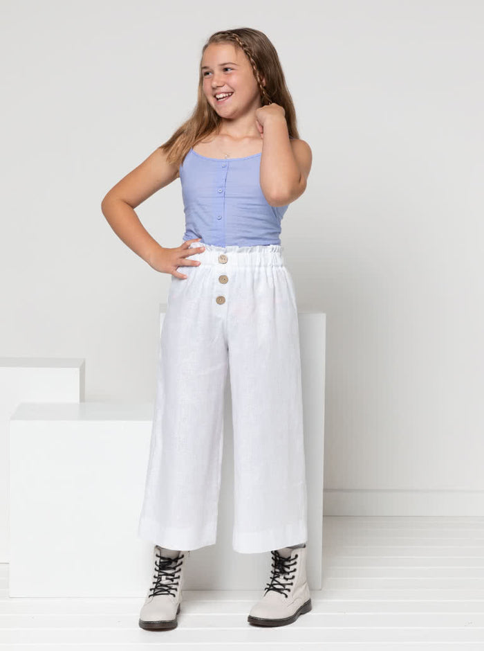Chic Penny Teens swing dress or top sewing pattern featuring a shirred back panel, rouleau straps, and a faux button opening, designed for cotton, linen, and rayon fabrics