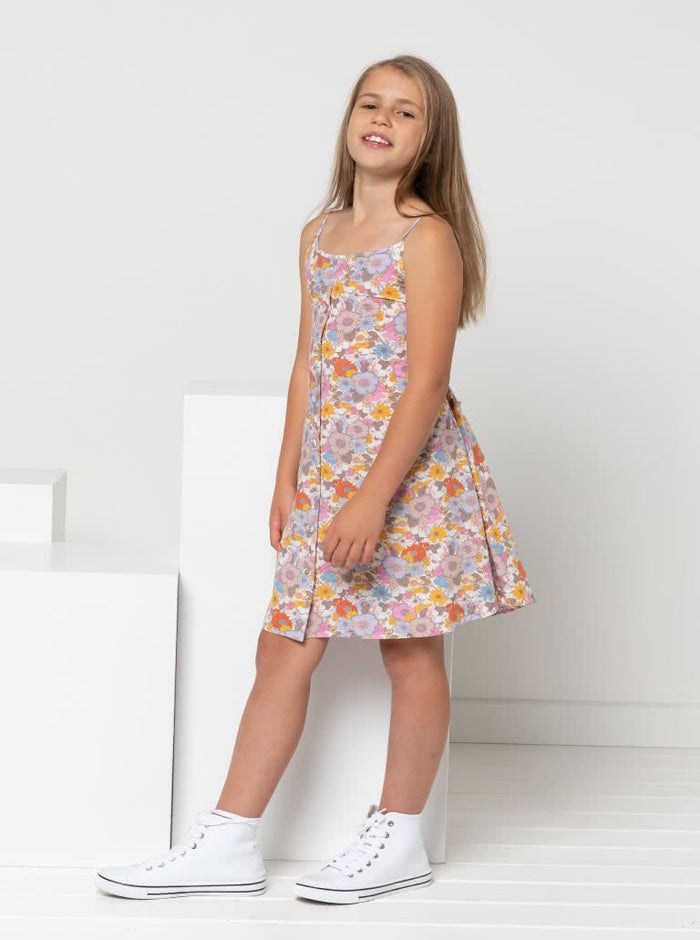 Chic Penny Teens swing dress or top sewing pattern featuring a shirred back panel, rouleau straps, and a faux button opening, designed for cotton, linen, and rayon fabrics