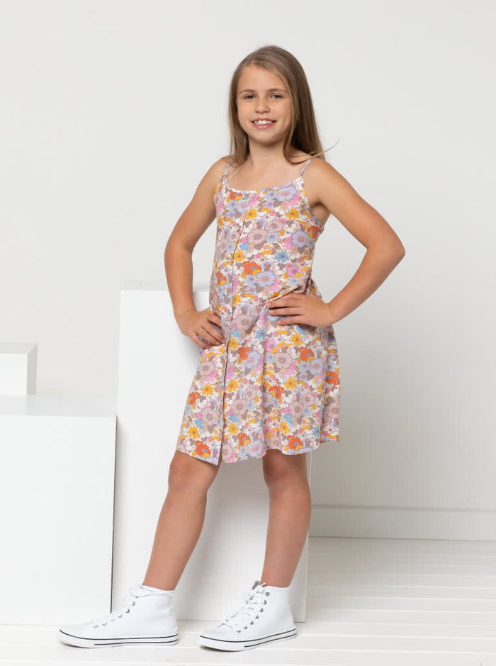 Chic Penny Teens swing dress or top sewing pattern featuring a shirred back panel, rouleau straps, and a faux button opening, designed for cotton, linen, and rayon fabrics