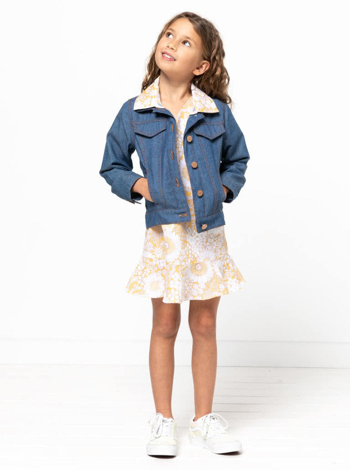 Adorable Pixie Kids Dress sewing pattern with an A-line shape, short flounce sleeves, and hem flounce, complete with a ‘V’ neck and loop & button back, perfect for young fashionistas