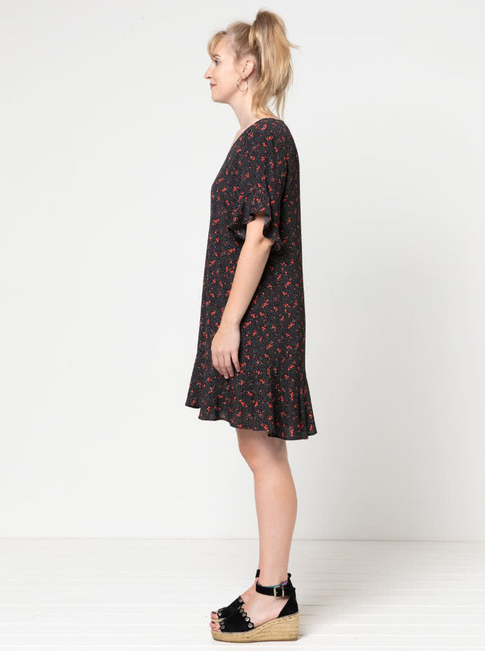 Stylish Pixie shift dress sewing pattern with short flounce sleeves, hem flounce, and a ‘V’ neck, designed for an easy fit and suitable for luxurious fabrics like silk and crepe