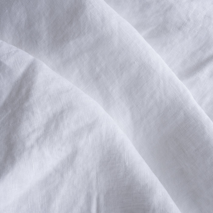 Close-up of extra wide white  linen fabric with folds
