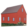 A wooden model of a red Quaker Meeting House with a gray roof, featuring details such as a front door and windows, set against a white background.