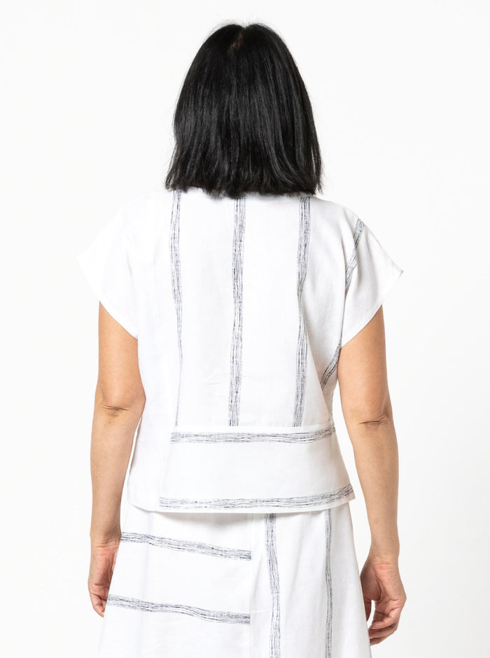 Quinn Woven Top sewing pattern with square cut, extended shoulder line, boxy shape, and front and back panelling.