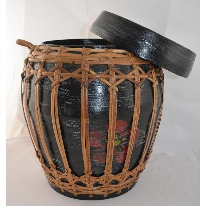 Natural rattan and bamboo lidded basket with woven cover and partially open lid, close-up view.