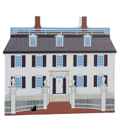 A decorative wood block of the Ropes Mansion with informative text on the reverse.