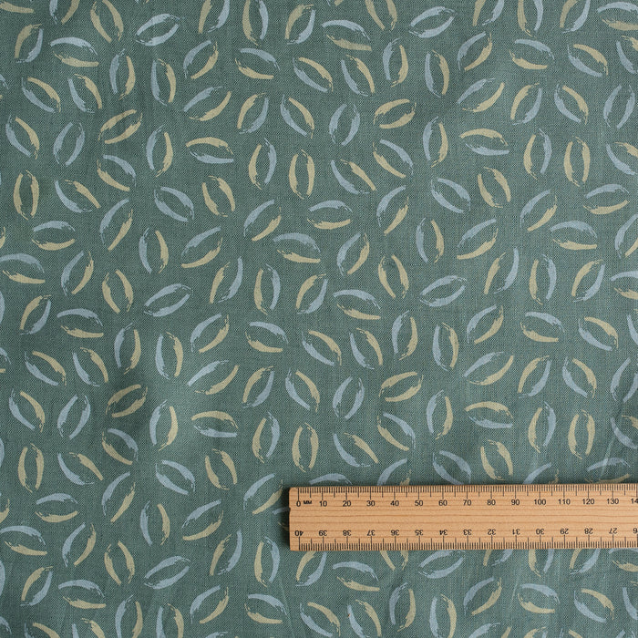 Sage Coast Print linen fabric with small botanical leaf motifs on a muted blue–green base