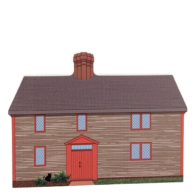 A wooden block replica of the Samuel Pickman House in Salem, Massachusetts, featuring the front view of the house with a red door and gray siding.