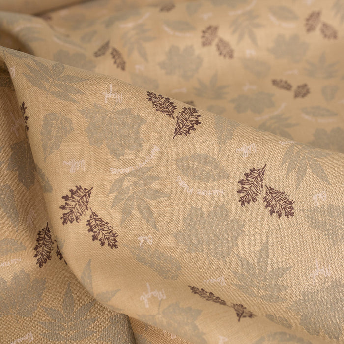 Nature-inspired Sand & Leaves linen fabric with a soft grip and leaf prints, perfect for creating stylish summer garments.