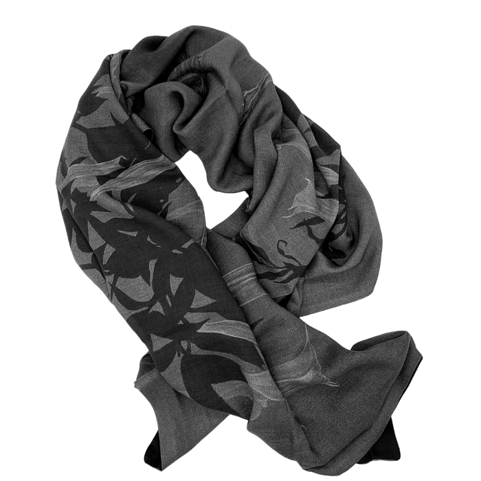A scarf with a floral pattern in shades of gray and black.