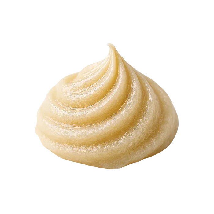 Close-up of a glossy pale yellow cream swirl of Sherbet Queen Live Whipped Diamonds on a white background