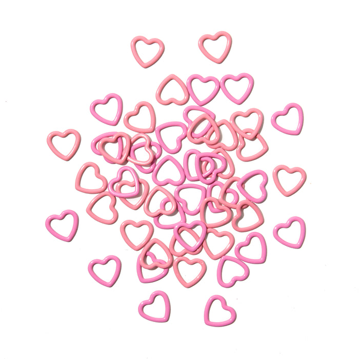 Pink heart-shaped objects scattered on a white background