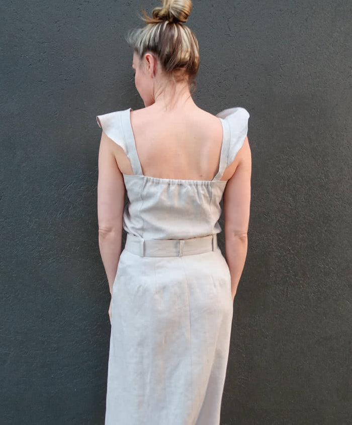 Stylish Sutton Woven Skirt sewing pattern featuring a mid-length A-line cut, button-through front, and belt, suitable for linen, crepe, or light wool