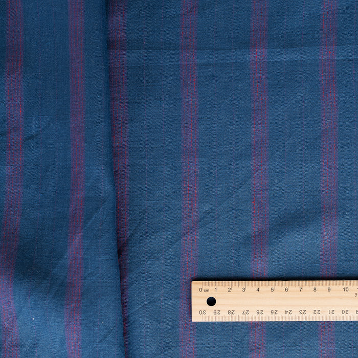 Tasman Tides linen fabric with deep blue base and vertical stripes in purple.