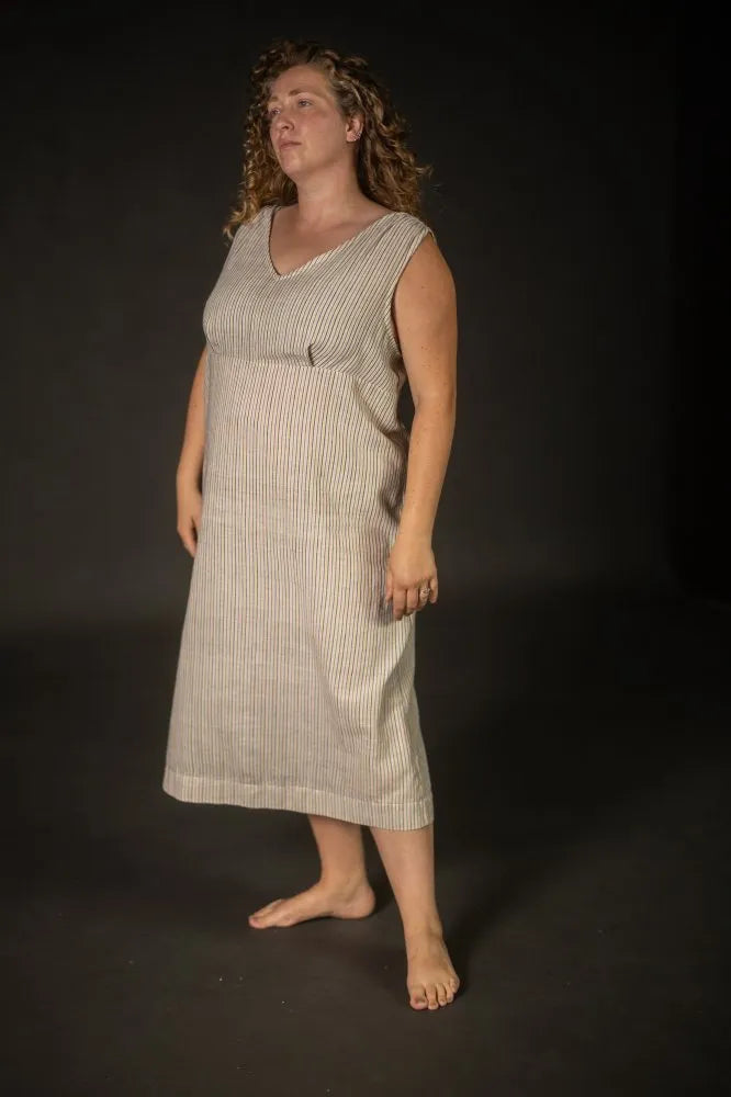 Woman wearing a sleeveless dress  made using The Lilian Sewing Pattern by Merchant & Millsagainst a black background