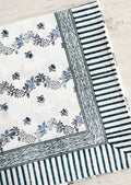 A block printed floral tablecloth in white and blue.