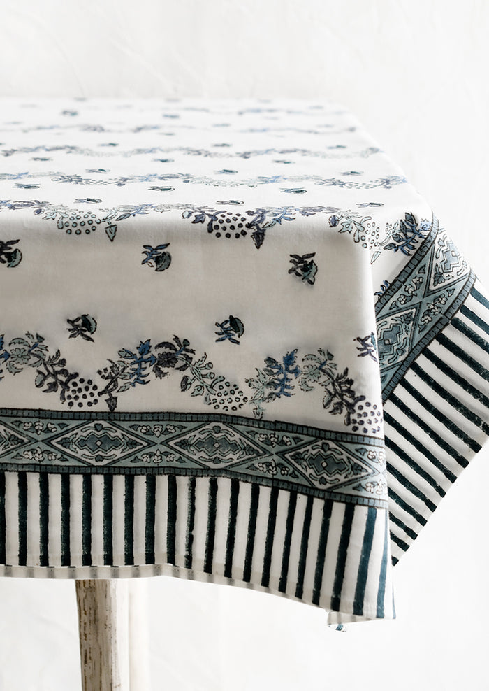 A block printed floral tablecloth in white and blue.