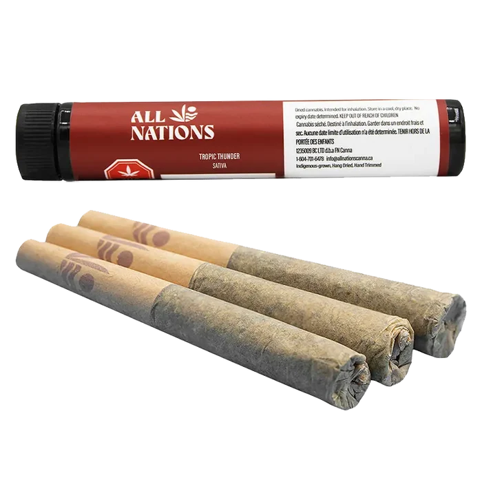 Angled close-up of three hand‑rolled joints in front of a red tube labeled Tropic Thunder PR 3 x 0.5 g by All Nations.